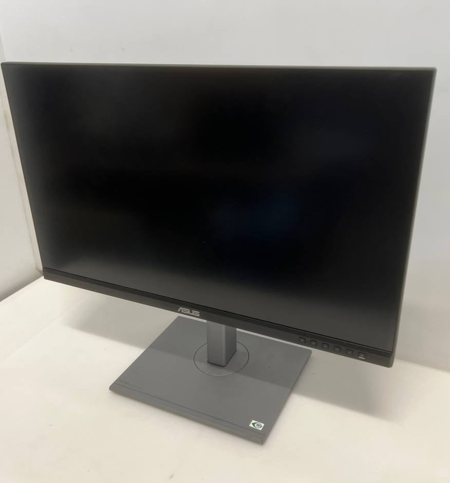 Black computer monitor on a white surface with a white wall background