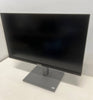 Black computer monitor on a white surface with a white wall background