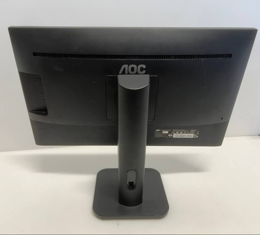 Black computer monitor with stand on a white surface