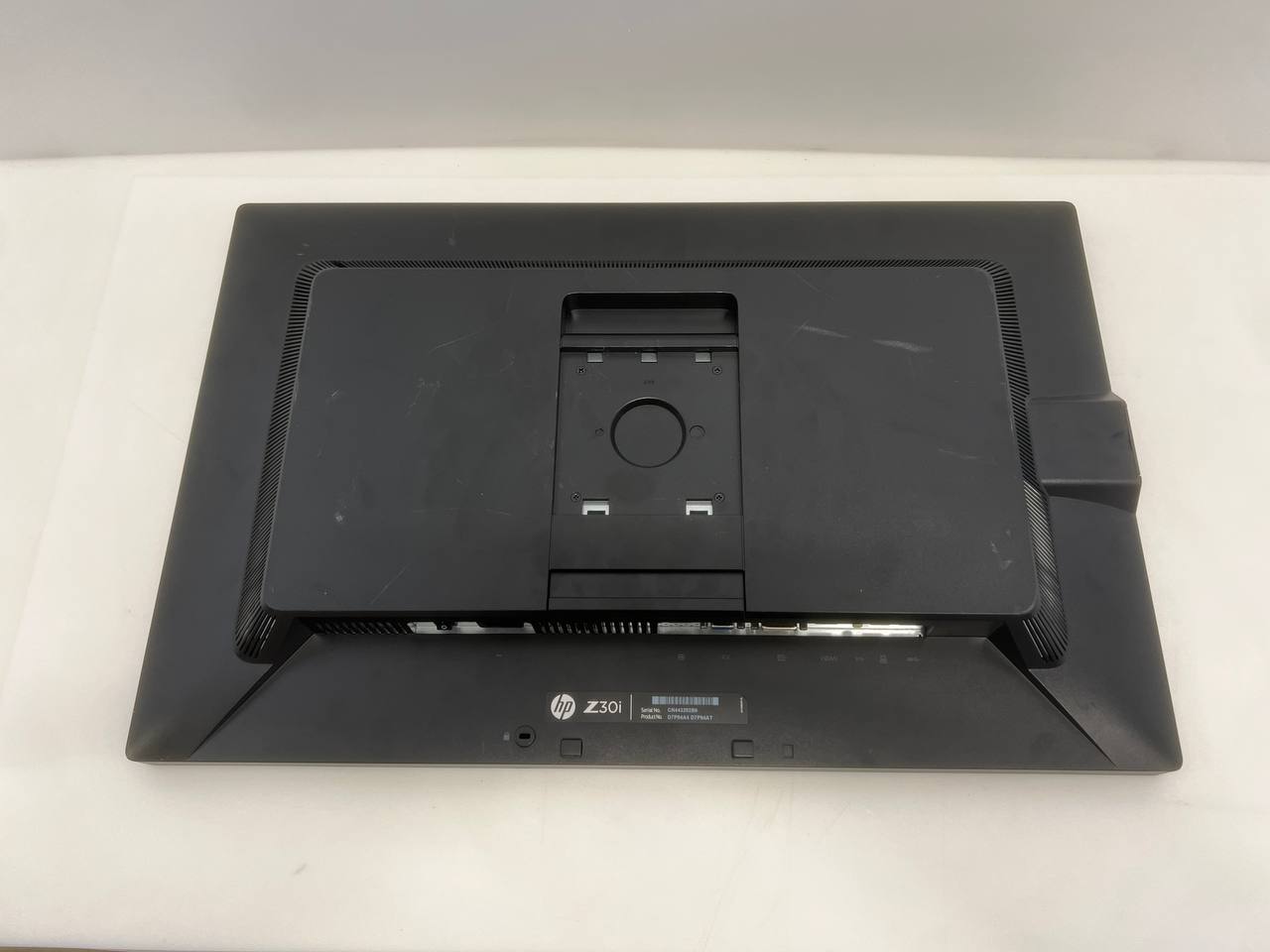 Back view of a black electronic device on a white surface
