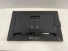 Back view of a black electronic device on a white surface